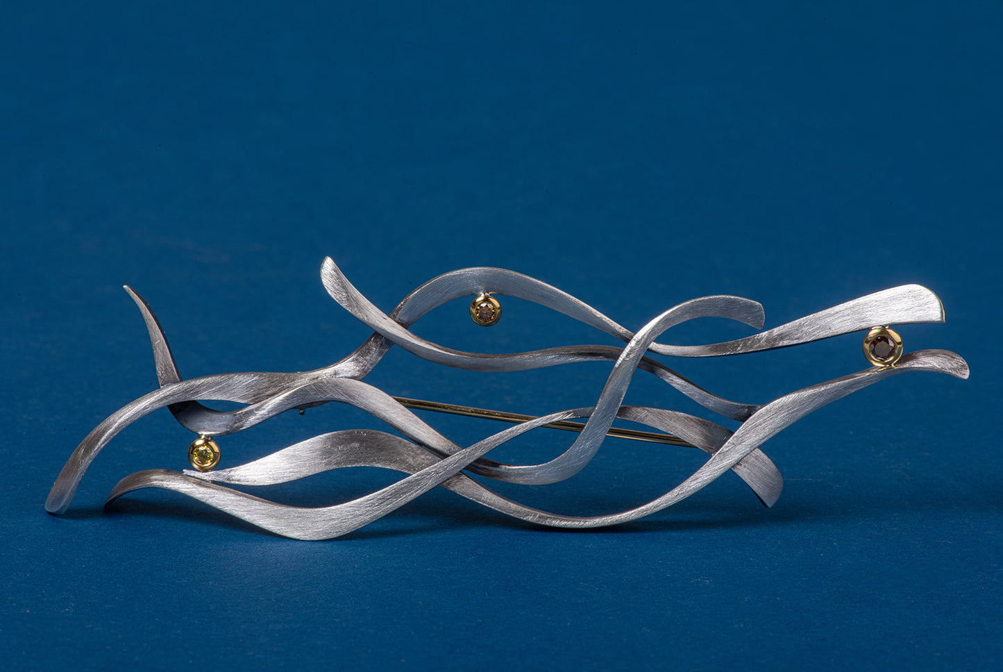 abstract brooch in sterling and gold with diamonds