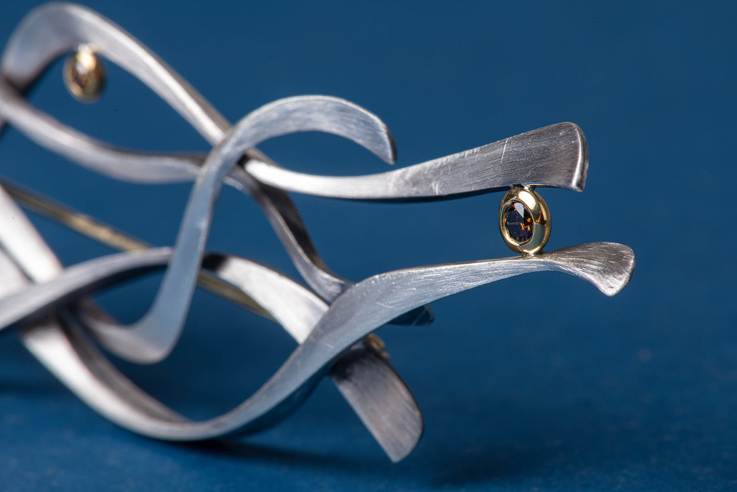 close up of diamond in abstract brooch