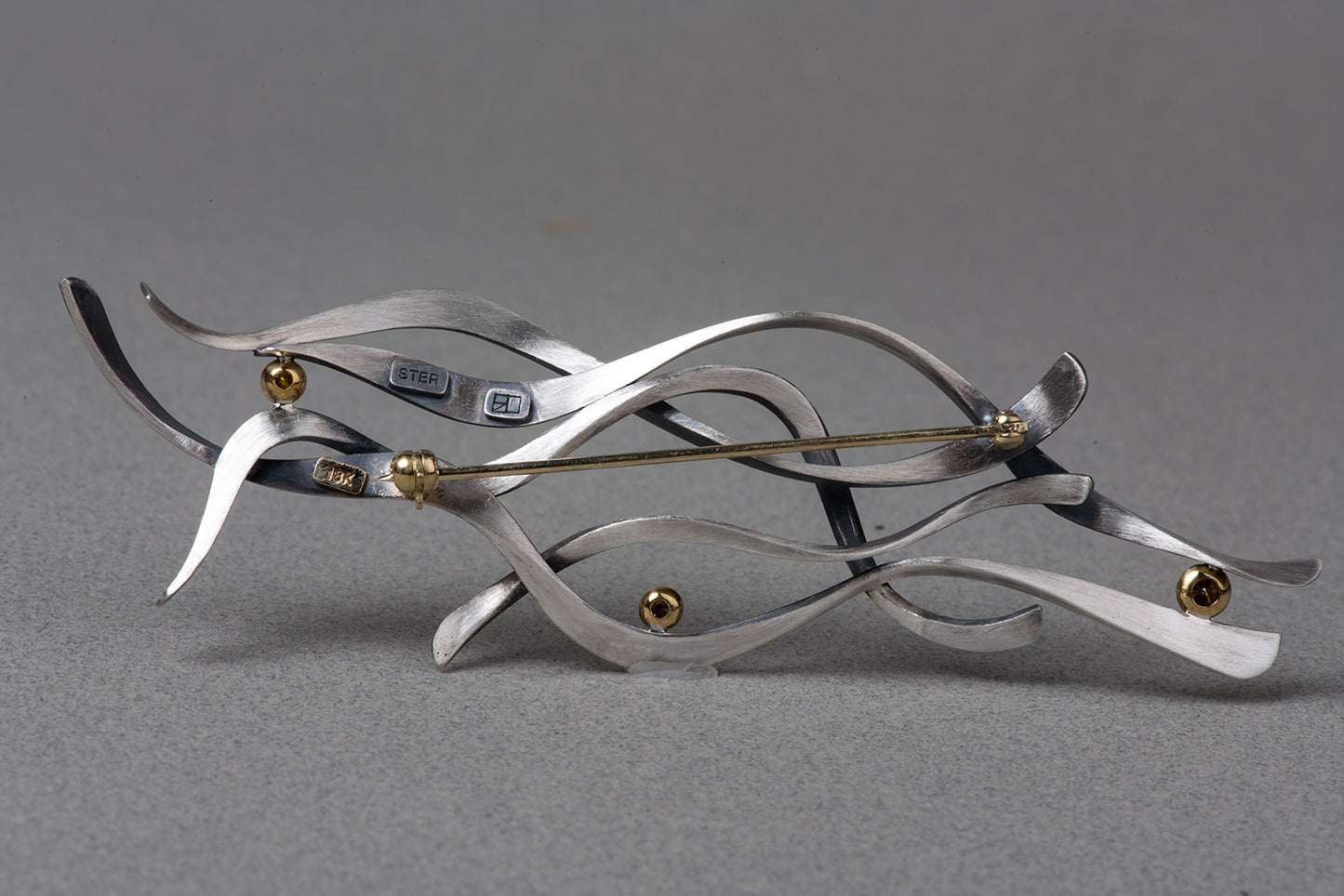 verso of abstract brooch showing clasp and settings