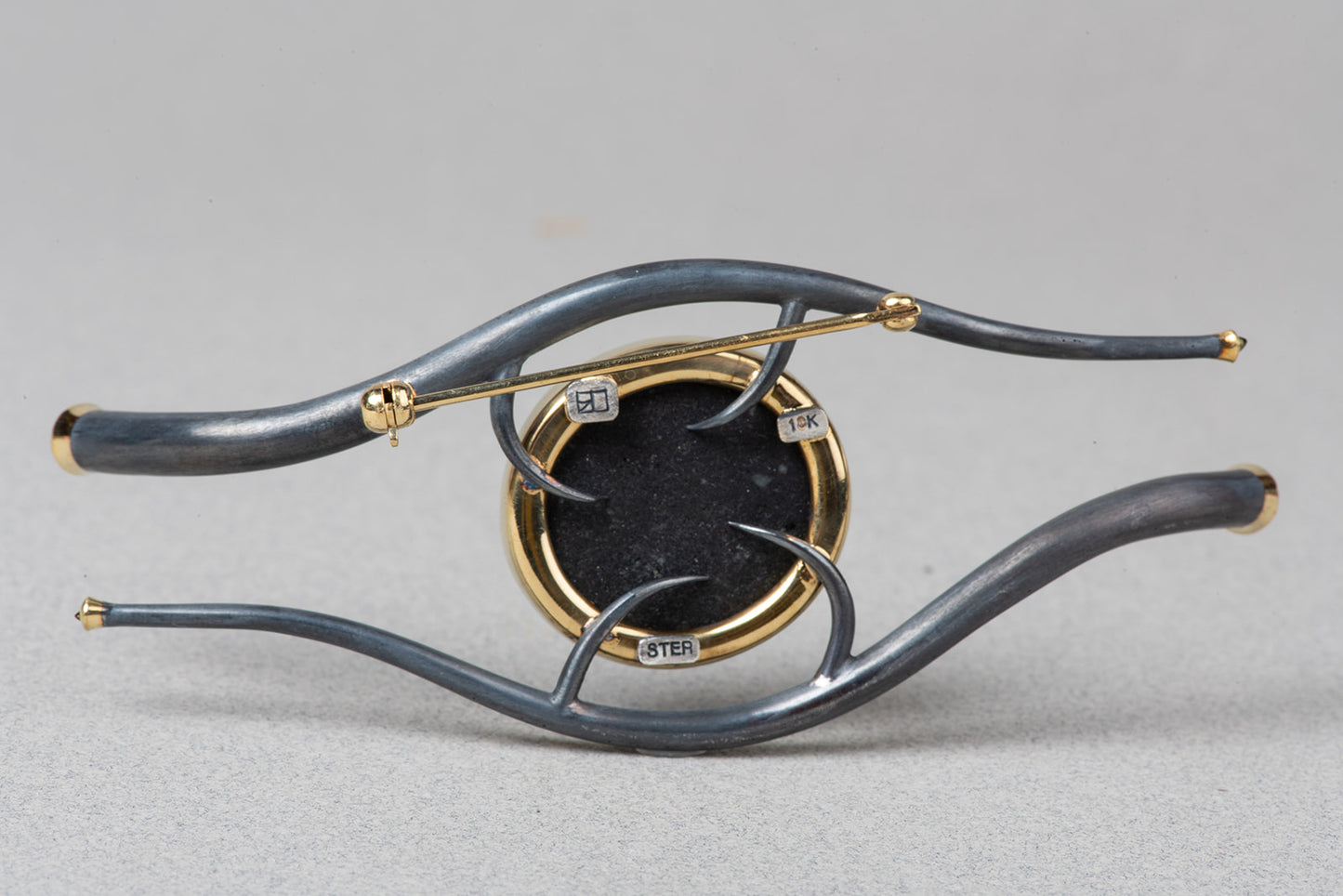 verso of Eye of Horus brooch showing clasp and stamps.