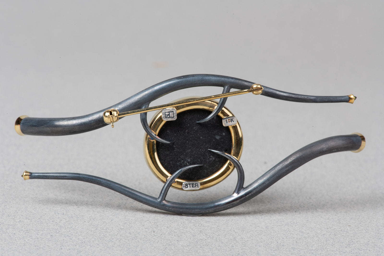 verso of Eye of Horus brooch showing clasp and stamps.