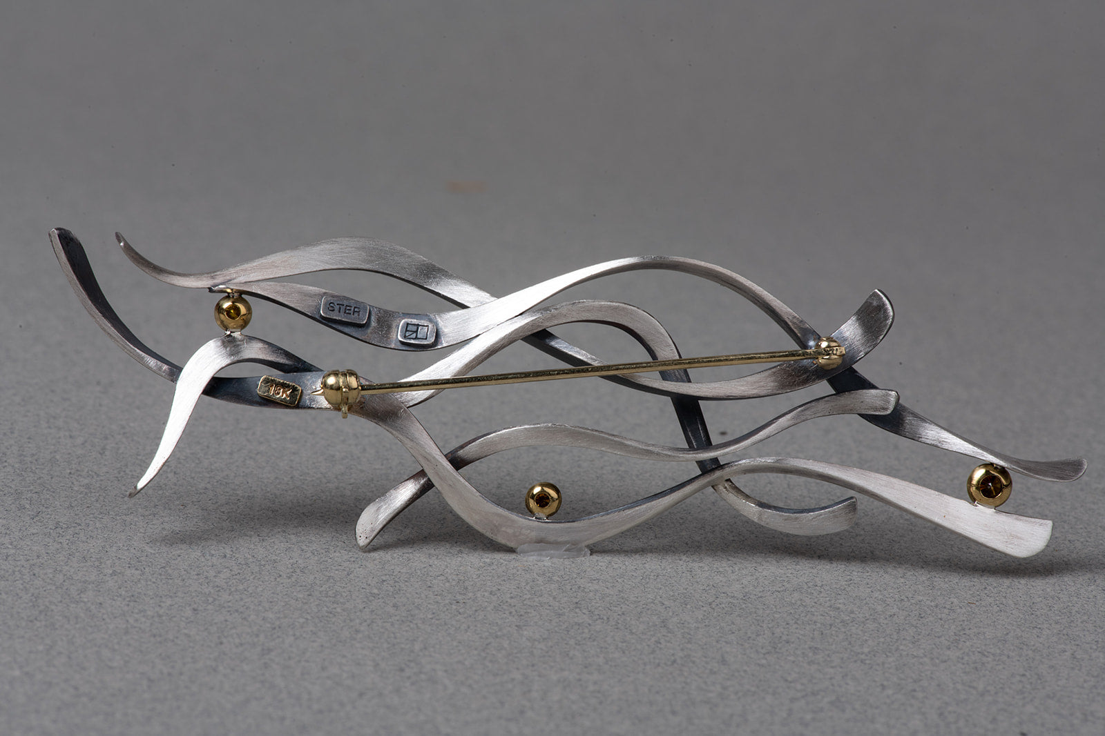 verso of abstract brooch showing clasp and settings
