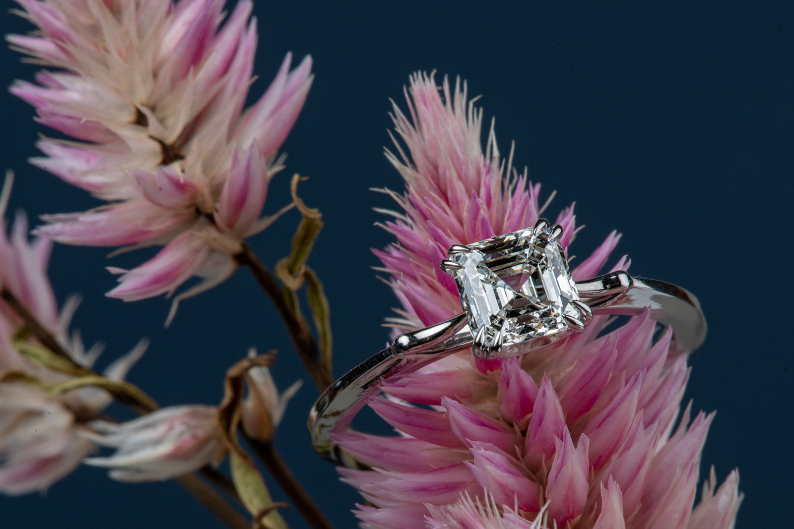 single stone diamond and platinum ring displayed on flower