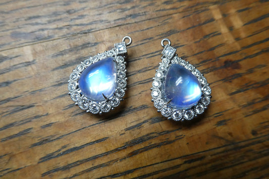 front view, moonstone earrings set with diamonds in platinum